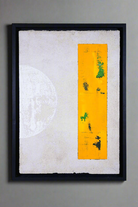 Framed artwork with a yellow strip featuring green abstract shapes on a textured white background.